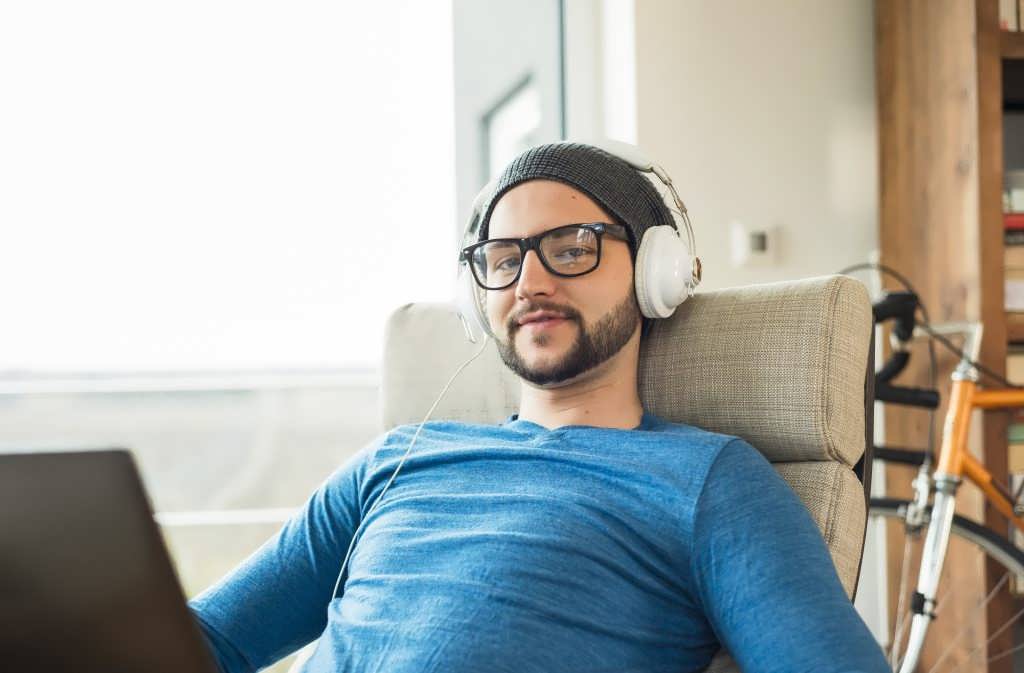 young-man-using-laptop-and-wearing-headphones-2022-03-08-01-33-08-utc-1024x673